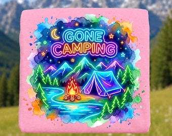 May include: Pink t-shirt with a neon-style camping scene. The design features a tent, mountains, a campfire, and the words "GONE CAMPING" in a neon font. The background has a watercolor effect with blues, greens, and oranges.