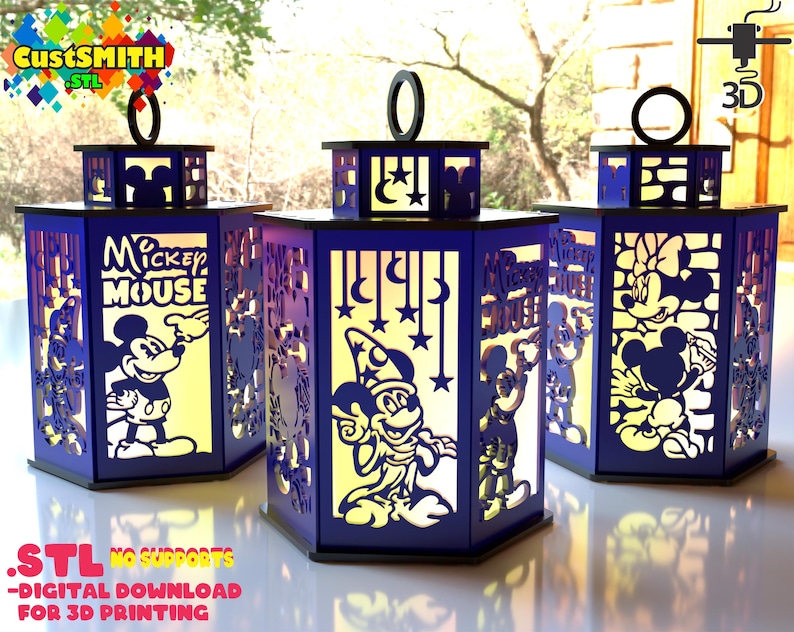 May include: Three illuminated, laser-cut lanterns featuring Mickey Mouse, Minnie Mouse, and a wizard Mickey Mouse. The lanterns are dark blue with black accents and have a handle on top. The text on the lanterns reads "Mickey Mouse". The bottom of the image reads ".STL NO SUPPORTS - DIGITAL DOWNLOAD FOR 3D PRINTING".