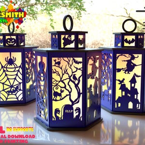 May include: Three Halloween-themed lanterns with intricate cut-out designs. Each lantern features a different spooky scene, including a spiderweb, a haunted house, and a witch on a broom. The lanterns are purple with a warm yellow glow.