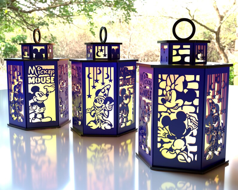 May include: Three hexagonal lanterns with Mickey Mouse and Minnie Mouse designs. The lanterns are dark blue with cut-out images and the words "Mickey Mouse". Each lantern has a black top with a circular handle.