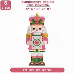 May include: A machine embroidery design of a nutcracker wearing a pink uniform with green accents, holding a white rectangular sign with a pink flower. Text reads: 5 SIZES, EMBROIDERY DESIGN FOR MACHINE, 4" 5" 6" 7" 8", PES DST EXP JEF VP3.