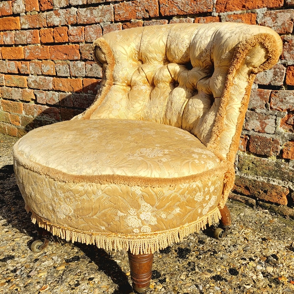 Vintage / Antique Edwardian buttoned back chair, upholstered in gold on short turned legs with casters