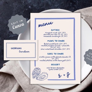 May include: A light blue and white menu with the text "menu" in blue cursive. The menu lists entrees, mains to share, sides to share, and dessert options. The text includes dietary restrictions such as "GF" for gluten-free and "DF" for dairy-free. The menu is on a white plate with a blue and white oyster illustration.