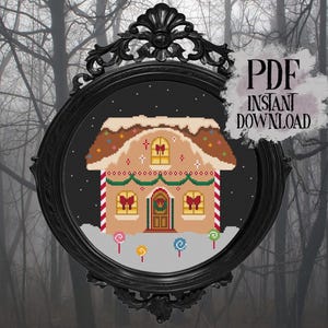 May include: A cross-stitch pattern of a gingerbread house with a snow-covered roof, red and white striped candy canes, and colorful lollipops. The image is framed in a black ornate oval frame with the text "PDF Instant Download".