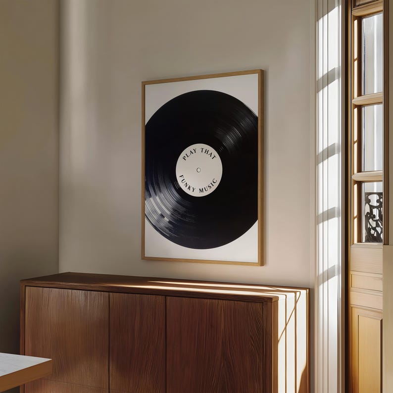 May include: A framed print of a black vinyl record with the text "Play That Funky Music" on a white background.
