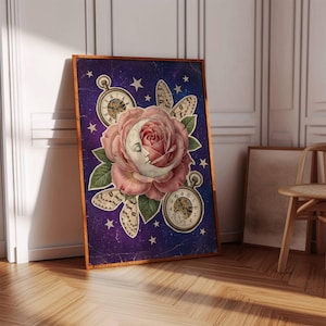 May include: A framed art print featuring a large pink rose with a crescent moon face at its center, set against a dark purple starry background. Two pocket watches and butterfly wings flank the rose. The frame is a warm brown.