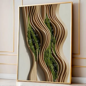 May include: A framed artwork featuring a 3D wooden sculpture with a wavy design. The sculpture has layers of light brown wood, with green plants and small white flowers filling the curved spaces. The frame is gold.