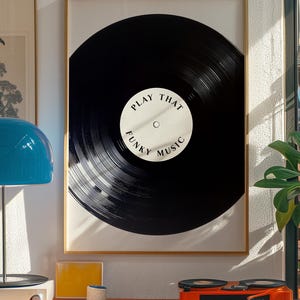 May include: A framed print of a black vinyl record with the text "Play That Funky Music" in white.
