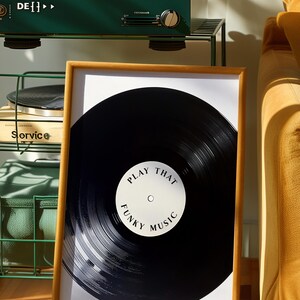 May include: A framed print of a black vinyl record with the text "Play That Funky Music" on a white label.