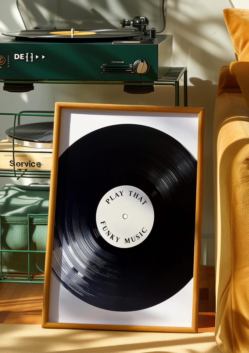 May include: A framed print of a black vinyl record with the text "Play That Funky Music" on a white label.