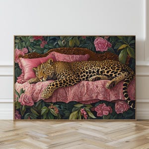 May include: A leopard is sleeping on a pink and gold chaise lounge with floral accents. The chaise lounge is surrounded by lush green foliage and pink flowers.