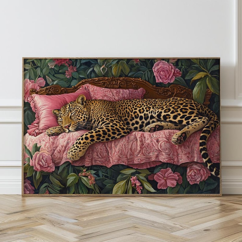 May include: A leopard is sleeping on a pink and gold chaise longue with floral accents. The chaise longue is surrounded by lush green foliage and pink flowers.
