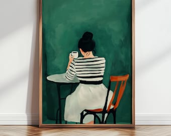 May include: A framed art print depicts a person seated at a table, holding a cup. The person wears a striped shirt and white skirt. The background is a solid green color, and the chair is a reddish-brown color.