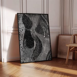May include: Black and white abstract art print with a swirling pattern of white dots on a black background. The print is framed in a black frame.