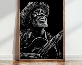 May include: Black and white framed print of a smiling man playing a guitar. The man wears a straw hat and a striped shirt. The guitar is in focus, with the man's hand on the strings.