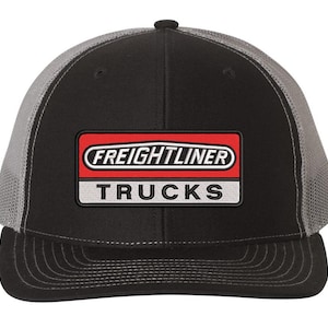 May include: A black and gray trucker hat with a red, white, and black embroidered patch that says "Freightliner Trucks".