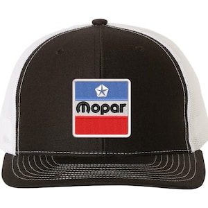 May include: Black and white trucker hat with a red, white, and blue Mopar logo patch. The logo features a star and the word "Mopar" in black.
