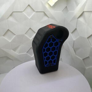 May include: Black 3D printed gear shift knob with a blue honeycomb pattern and the word "TRD" in red lettering.