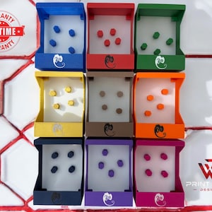 May include: A set of nine colorful dice trays with different colored dice. Each tray has a different color and a wave design. The trays are made of plastic and are designed to hold dice. The trays are arranged in a 3x3 grid. The trays are all the same size and shape. The dice are all the same size and shape. The dice are all different colors. The dice are all made of plastic. The trays are all made of plastic. The trays are all the same size and shape. The dice are all the same size and shape. The dice are all different colors. The dice are all made of plastic.