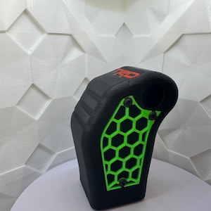 May include: Black and green 3D printed gear shift knob with a honeycomb pattern and the word "TRD" printed in red.