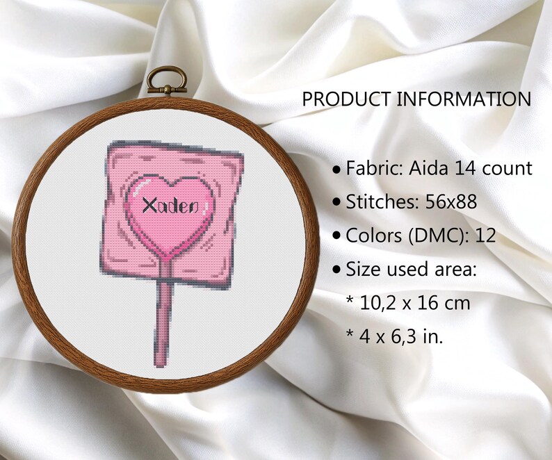 May include: A cross-stitch design of a pink lollipop with a heart-shaped center and the name "Xaden". The design is framed in a wooden embroidery hoop. The size of the design is 4 x 6.3 inches.