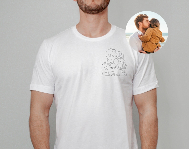 May include: White t-shirt with a line drawing of a person holding a child.
