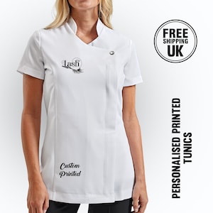May include: White short-sleeved tunic with a black logo that says "Dr Lash" and a black feather design. The tunic also has the text "Custom Printed" on the bottom left side.