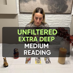 May include: A tarot card reading setup featuring three tarot cards laid out on a white tablecloth, a small matryoshka doll, a gold cat figurine, and a pillar candle. The text UNFILTERED EXTRA DEEP MEDIUM READING is overlaid in green and white.