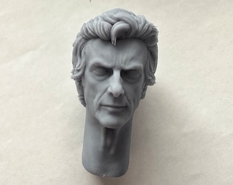 May include: A gray, detailed bust of a man's head and neck. The sculpture features realistic facial details, including wrinkles and textured hair. The figure has a stern expression.