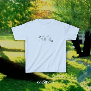 May include: Light blue t-shirt with the text "Kiss Me I'm Irish" and two shamrock designs.