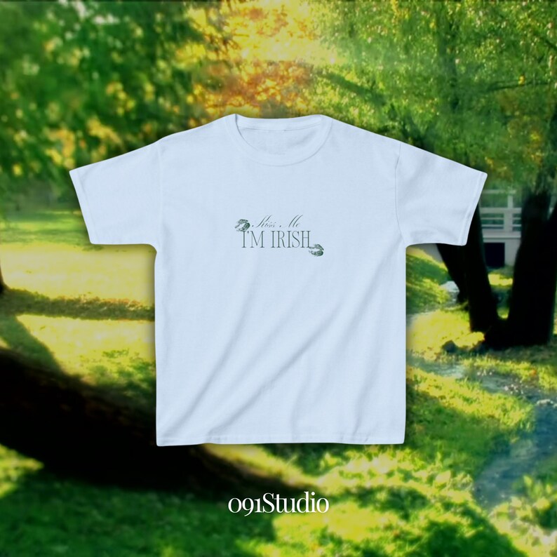 May include: Light blue t-shirt with the text "Kiss Me I'm Irish" and two shamrock designs.