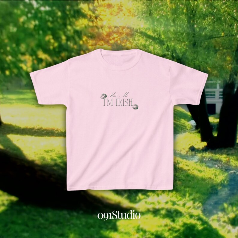 May include: Pink t-shirt with the text "Kiss Me I'm Irish" and a shamrock design.