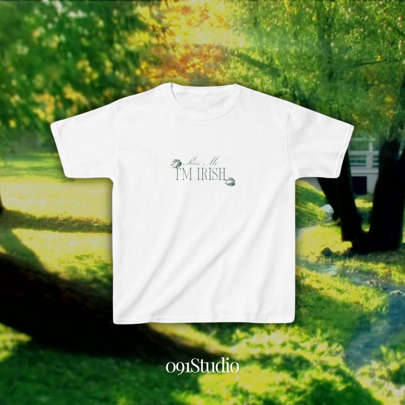 May include: White t-shirt with the text "Kiss Me I'm Irish" and a shamrock design.
