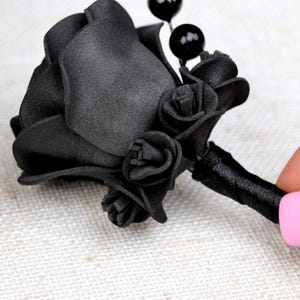 a woman's hand with a pink and black manicure