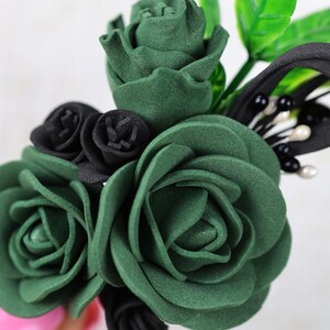 a close up of a person holding a fake flower