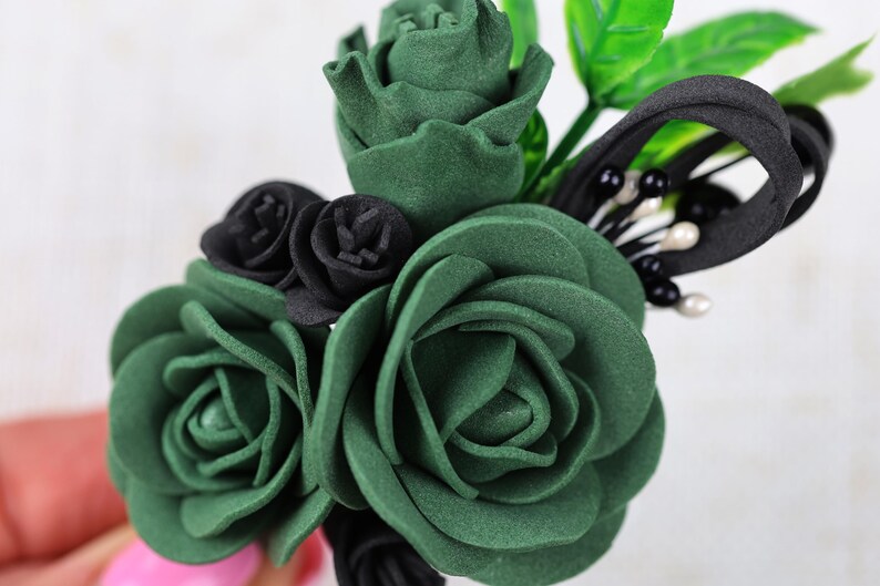 a close up of a person holding a fake flower