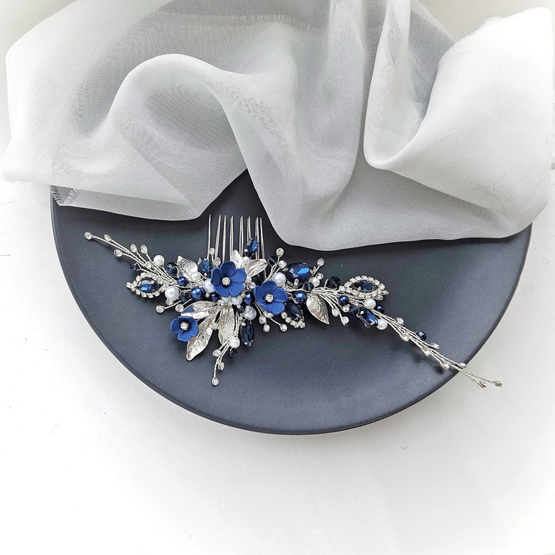a blue plate topped with a blue and silver brooch
