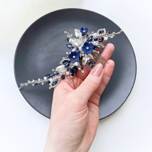 a woman is holding a hair comb on a plate