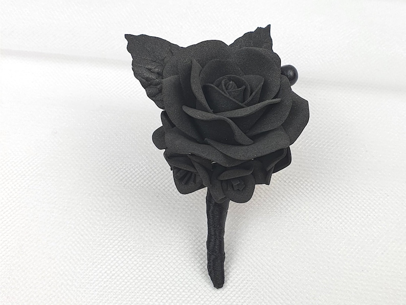 a single black rose on a white background