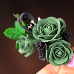 a close up of a person holding a fake flower