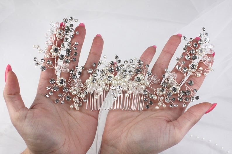 a woman's hand holding a bridal hair comb