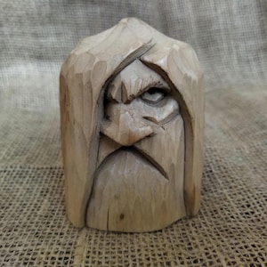 Odin statue. Handmade wooden statue of the god Odin. Scandinavian mythology. Wood carving.