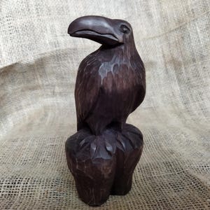 Raven statue carved from wood by hand. A handmade wooden crow figurine carrying forest wisdom, quiet mystery, and protective magic.
