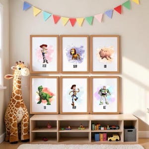 May include: Six framed wall art prints featuring watercolor-style illustrations of Toy Story characters Jessie, Slinky Dog, Hamm, Rex, Woody, and Buzz Lightyear, each with their name printed below the character on a white background.