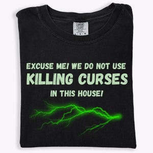 May include: Black t-shirt with a green lightning bolt graphic and the text "EXCUSE ME! WE DO NOT USE KILLING CURSES IN THIS HOUSE!"