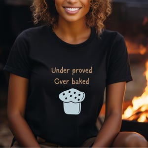 May include: A black t-shirt with the text "Under proved Over baked" and a cartoon image of a muffin with chocolate chips.