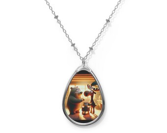 May include: A silver necklace with a teardrop-shaped pendant featuring a cartoon bear and moose inside. The pendant has a silver border and a warm, orange glow.