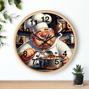 May include: A circular wall clock with a light wood frame. The clock face depicts a cartoon chef in a white uniform, stirring a pot of food. The clock hands are black, and the numbers are in a classic font. The background shows a kitchen setting.