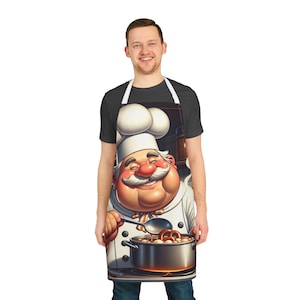 Könnte beinhalten: Schürze mit einem Cartoon-Koch-Design. Der Koch hat einen großen weißen Schnurrbart und eine Kochmütze und hält einen Löffel über einem Topf mit Essen. Das Schürzen-Design zeigt einen lächelnden Koch mit roter Nase und Wangen sowie eine weiße Kochuniform.