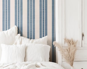 May include: Wallpaper featuring vertical stripes in alternating shades of blue and cream. The blue stripes contain a thin, repeating cross pattern. The text "little forest KIDS" with a squirrel icon is visible in the upper right corner.